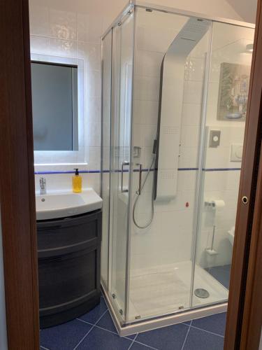 a bathroom with a glass shower and a sink at Casa Paola nel Chianti in Castelnuovo Berardenga