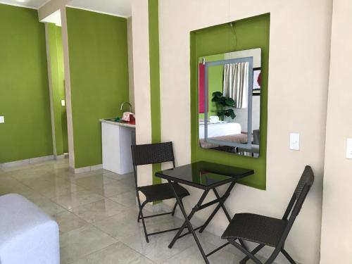 a room with a table and chairs and a mirror at Casa Mia in Puerto Escondido