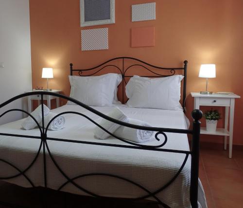 a bedroom with a bed with white sheets and pillows at MIRA VILA by Stay in Alentejo for HIKERS in Vila Nova de Milfontes