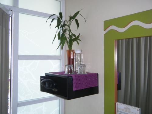 a room with a plant on a table next to a window at Casa Mia in Puerto Escondido