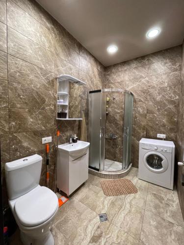 a bathroom with a toilet and a shower at Melikishvili str. apartment in Tbilisi City