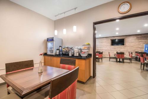 a restaurant with a counter and a table and chairs at Comfort Inn Newport in Newport