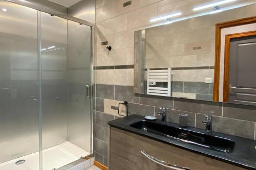 une salle de bain avec un lavabo et une douche en verre dans l'établissement Vaste T4 115m2. Balcon. Vue. Suite. Jardin et jeux, à Cauterets