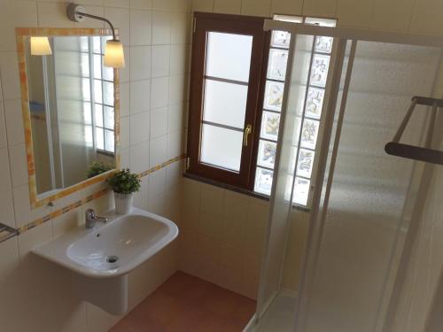 a bathroom with a sink and a shower at MIRA VILA by Stay in Alentejo for HIKERS in Vila Nova de Milfontes