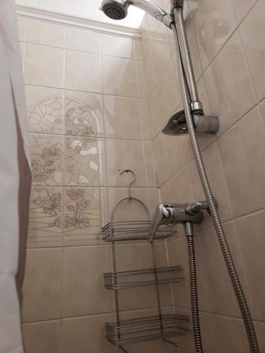 a shower with a shower head in a bathroom at Fernlea Hotel in Blackpool