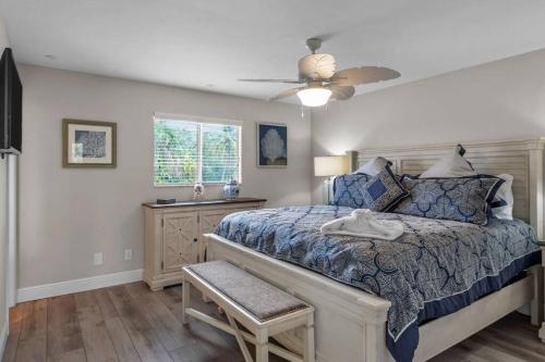 a bedroom with a bed and a ceiling fan at The Tequila Sunrise at Lazy Way in Fort Myers Beach
