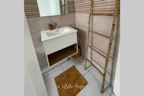 a small bathroom with a sink and a ladder at Villa Auya entre mer et montagne in Le Carbet