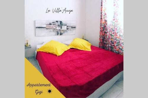 Villa Auya entre mer et montagne في لو كاربيت: غرفة نوم مع بطانية حمراء وصفراء على سرير