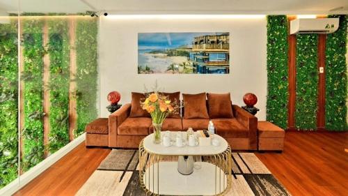a living room filled with furniture and flowers at Mira Eco Hotel Quy Nhơn in Quy Nhon