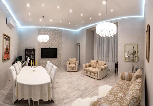 a living room with a white table and chairs at Sky Apartment in Debrecen