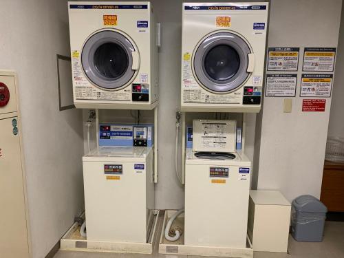 a group of washing machines and washers in a room at Iga Ueno City Hotel in Iga