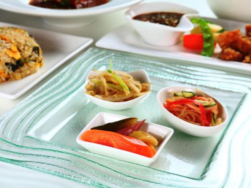 a tray with several small dishes of food on it at Pension Kobekko in Otari