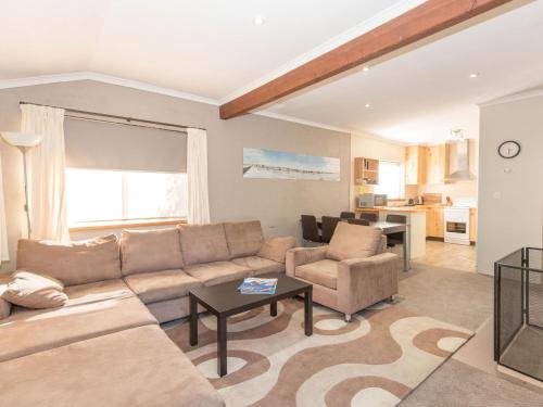 a living room with a couch and a table at Charvel 2 35 Gippsland Street in Jindabyne