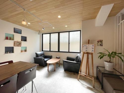 a living room with two chairs and a table at Guest House Laule'a Tennoji in Osaka