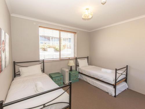 a bedroom with two beds and a window at Horizons 219/10 Kosciuszko Road in Jindabyne