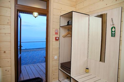 a door to a tiny house with a view of the ocean at Chayka Resort in Odesa