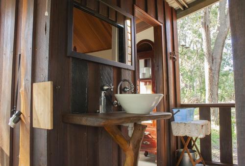 a sink in a small room with a wooden cabinet at Barrabup Sanctuary BirdHide in Nannup