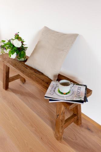 a coffee table with a cup of coffee and a newspaper at Winzer Appartements Kogler in Leutschach