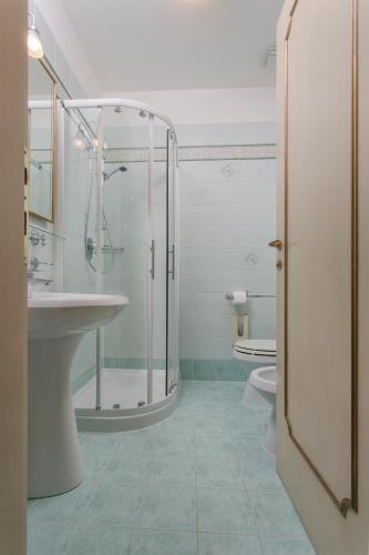 a bathroom with a shower and a sink and a toilet at Locanda Cà Le Vele in Venice