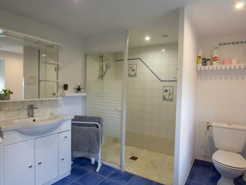 a bathroom with a toilet and a sink and a shower at Maison de campagne avec piscine, proche de Périgueux – 2 chambres, BBQ, activités variées à proximité - FR-1-616-54 in Mensignac