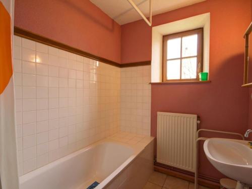 a bathroom with a tub and a sink at Gîte La Chambonie, 4 pièces, 6 personnes - FR-1-496-197 in La Chambonie