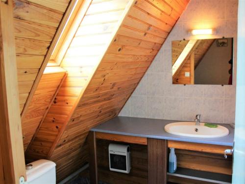 an attic bathroom with a sink and a mirror at Gîte Belvès, 4 pièces, 6 personnes - FR-1-616-86 in Larzac