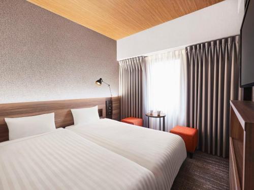 Un pat sau paturi într-o cameră la RIHGA PLACE HIGOBASHI