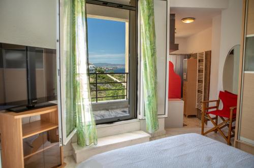 a bedroom with a large window with a view at BIG BLUE in Rafina