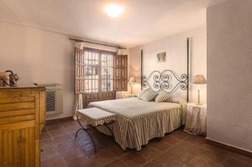 um quarto com uma cama grande e uma janela em Halo - Typical Spanish Downtown House Close To The Sea em Marbella