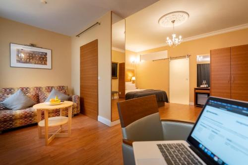 a living room with a laptop computer in a room at Hotel Kleiner Riesen in Koblenz
