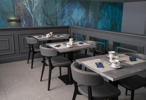 a dining room with tables and chairs and a mural at Sole Mare in Ventimiglia