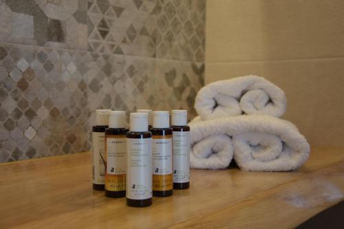 a group of four bottles of lotion on a table at Villa Nelleas in Adamas