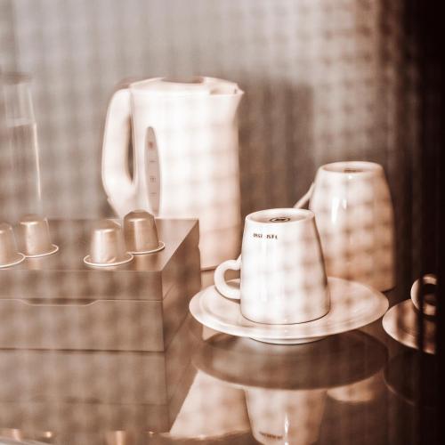 a counter with two cups and two vases on it at Olympic Hotel in Amsterdam