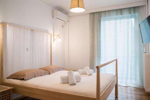 a bedroom with a bed with towels on it at Cozy Apartment in Central Athens - Sleeps 5 in Athens