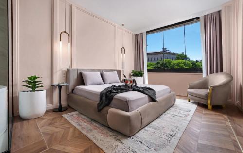 a bedroom with a bed and a couch and a chair at Walton Gardens Pera in Istanbul