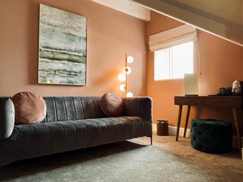 a living room with a couch and a piano at The Spa Hotel in Saltburn-by-the-Sea