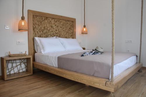 a bedroom with a bed with a hanging bed frame at Villa Nelleas in Adamas