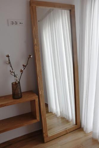 a mirror sitting on a wooden shelf next to a window at Villa Nelleas in Adamas