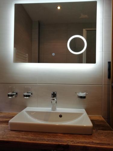 a white sink in a bathroom with a mirror at Bichlhof in Niederthai