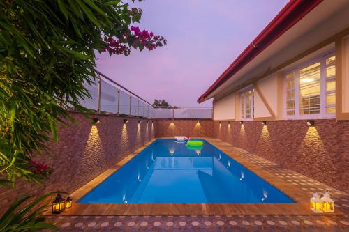 a swimming pool in the backyard of a house at StayVista's V Square - Enjoy a pool and indoor games for a leisurely stay in Lonavala