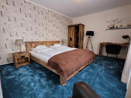 1 dormitorio con cama y pared de ladrillo en Hotel Aquarius, en Norddeich