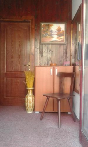 a room with a table and a chair and a vase at Villa Renesans in Star Dojran