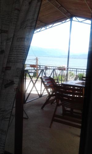 a view of a porch with chairs and an umbrella at Villa Renesans in Star Dojran