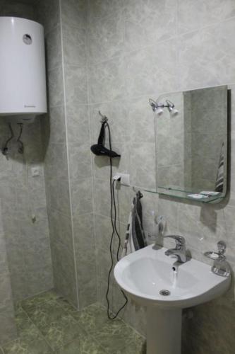 a bathroom with a sink and a mirror at Sevan Hotel in Sevan