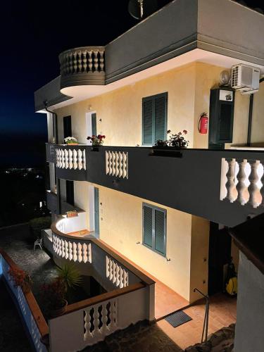 a view of a building with a balcony at night at Villa Bella Vista in Santa Domenica