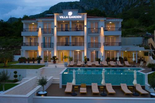 a hotel with a swimming pool and a resort at Garden Recovery in Sveti Stefan