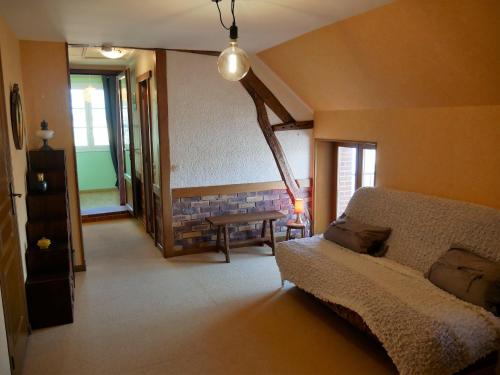 a living room with a bed and a table at Charmante Maison pour 6 à St Père-sur-Loire, Vue Loire - FR-1-590-178 in Saint-Père-sur-Loire