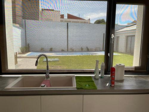 a kitchen counter with a sink and a window at Casa Juliana in Herencia