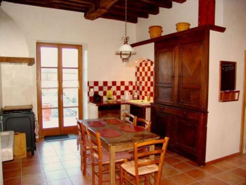 a kitchen with a table and chairs in a room at Maison de Caractère 14ème Siècle, 6 Pers., Grand Jardin & Cheminée, Près de Nancy et Verdun - FR-1-585-46 in Void