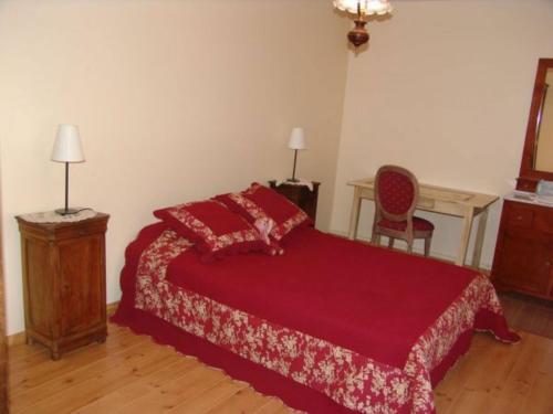 a bedroom with a red bed and a desk at Maison de Caractère 14ème Siècle, 6 Pers., Grand Jardin & Cheminée, Près de Nancy et Verdun - FR-1-585-46 in Void